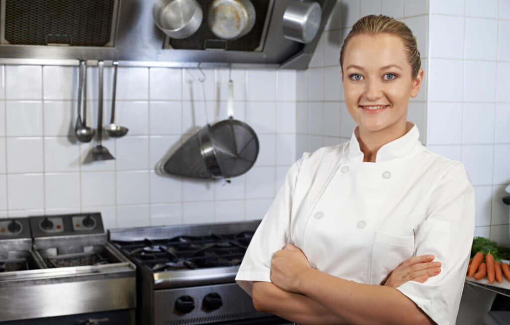 About Forkful Daily 1 Maya Bennett, the recipe creator and face behind Forkful Daily, smiling confidently in a professional kitchen
