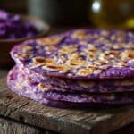 Purple Sweet Potato Roti stacked on wooden board with golden spots