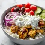 Fluffy rice, golden chicken strips, cucumber, tomatoes, red onion, Kalamata olives, feta, tzatziki dollop – Greek Chicken Bowls.