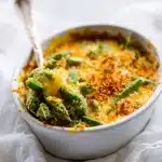 Golden, cheesy okra casserole with crispy panko crust, bubbling cheddar, and green okra slices in a baking dish, recipe for okra casserole.