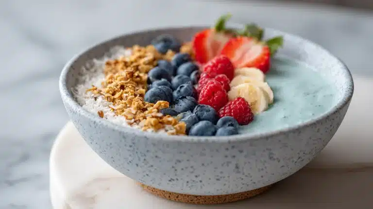Sleep recovery smoothie bowl with tart cherries, pumpkin seeds, and honey drizzle on marble