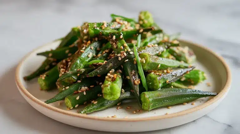 Crispy stir fry okra recipes served in a bowl with sesame seeds and scallions