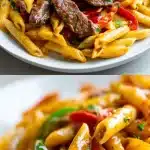 A stunning overhead shot of creamy Cajun steak pasta in a shallow bowl. Tender, seared sirloin strips with a pink center rest on twirled penne coated in a glossy, golden parmesan Cajun cream sauce, garnished with fresh parsley and vibrant red and yellow bell pepper slices.
