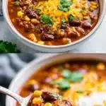 A vibrant, steaming bowl of hearty meatless chili loaded with red kidney beans, black beans, sweet corn, and topped with melting shredded cheddar cheese, fresh cilantro leaves, and a lime wedge, with tortilla chips on the side.