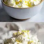 A rustic ceramic bowl filled with fresh, creamy homemade cottage cheese curds, drizzled with heavy cream and garnished with bright yellow lemon zest, set on a wooden kitchen table.