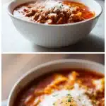 Overhead shot of a steaming bowl of lasagna soup, featuring a rich red tomato broth, visible broken lasagna noodles, crumbled Italian sausage, and a generous melting dollop of ricotta and mozzarella cheese on top, garnished with fresh basil.
