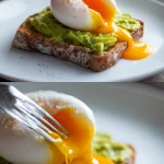 A single, perfectly oval poached egg with a glossy white exterior rests on rustic sourdough toast spread with smashed avocado. The egg is cut open, revealing a bright orange, runny yolk that drips onto the toast. The plate sits on a light wood table with scattered sea salt and a fork nearby.