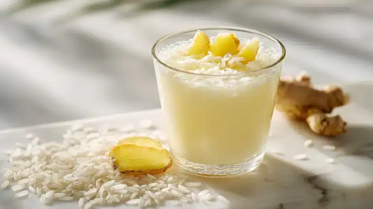 Warm mug of starchy rice water for digestion on a rustic board